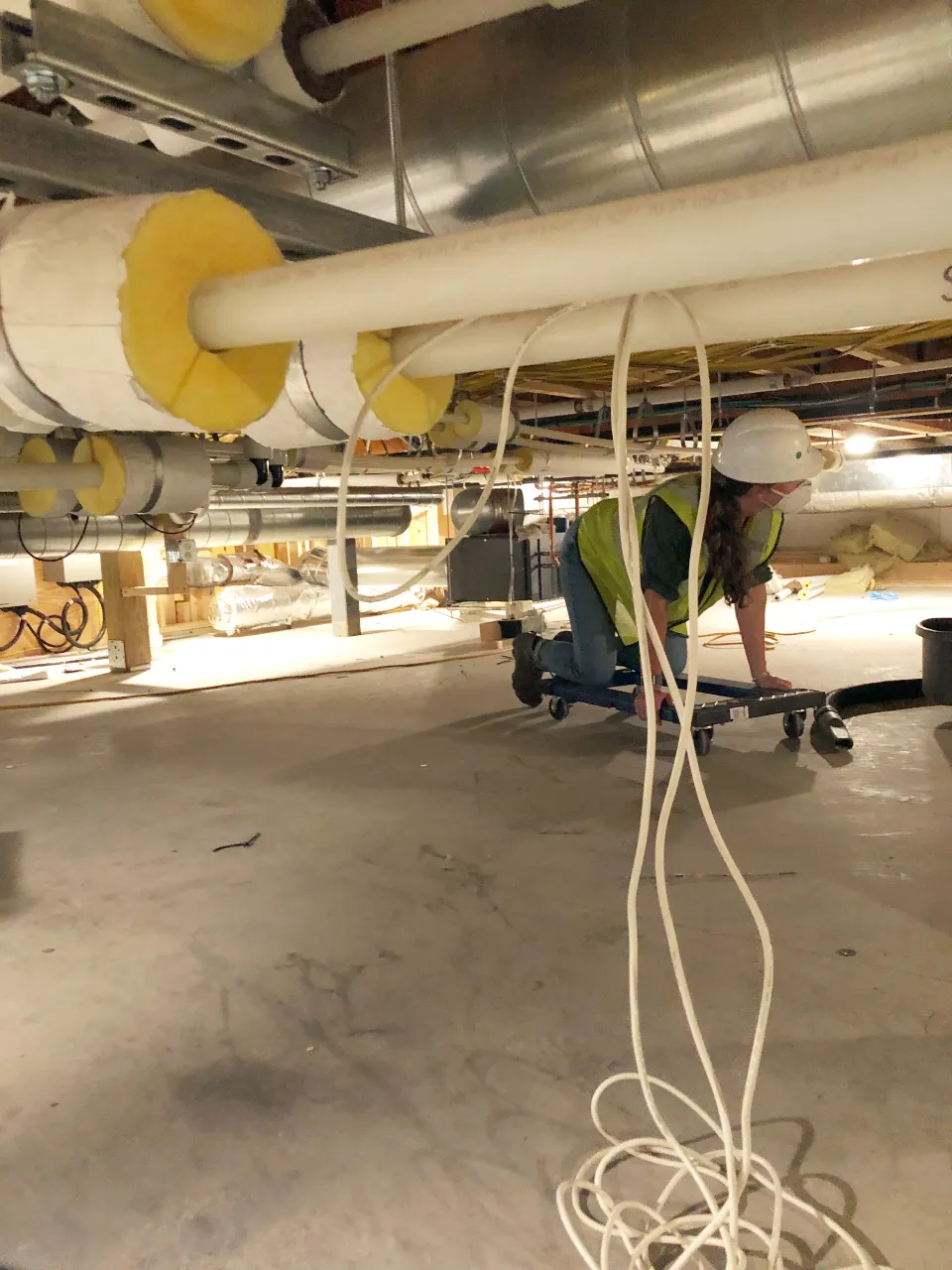 An engineers inspects piping