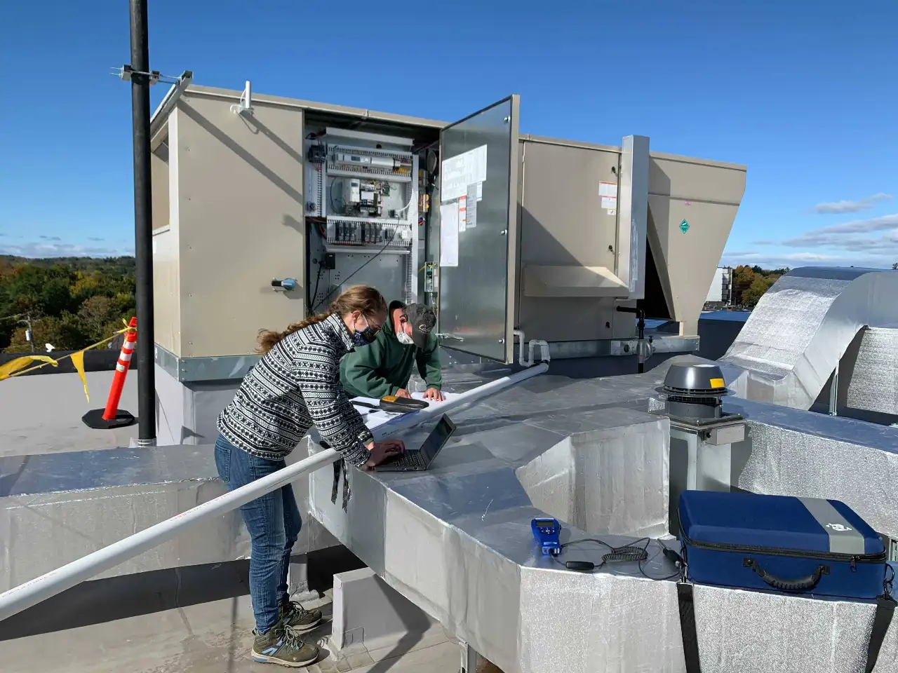 Engineer Reviewing Equipment on a Rooftop